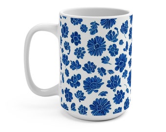 May include: White ceramic mug with a blue floral pattern. The mug has a large handle and is a standard size.