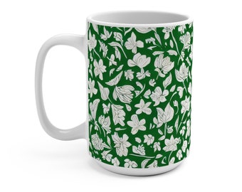 May include: White ceramic mug with a green background and a white floral pattern.