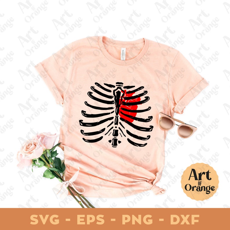 May include: A pink t-shirt with a black and white ribcage design and a red heart inside. The text "Art of Orange" is in a circle on the bottom right corner of the image.
