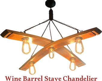 May include: A rustic wine barrel stave chandelier with five light bulbs. The chandelier is made of natural wood and has a dark brown finish. The light bulbs are Edison style and give off a warm glow.