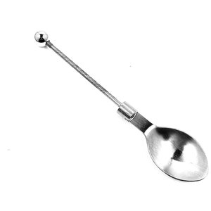 May include: A silver spoon with a long, thin handle and a round ball at the end. The spoon is designed for scooping out small items.