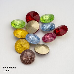 May include: Assortment of 12 mm round rivoli rhinestones in various colors, including red, green, blue, gold, and pink. The rhinestones have a faceted design and a shiny finish.
