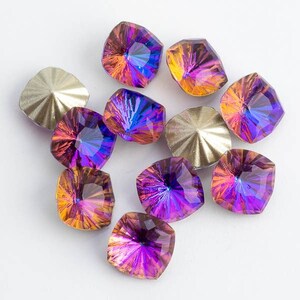 May include: Assortment of iridescent purple and orange square-shaped rhinestones with a faceted design.