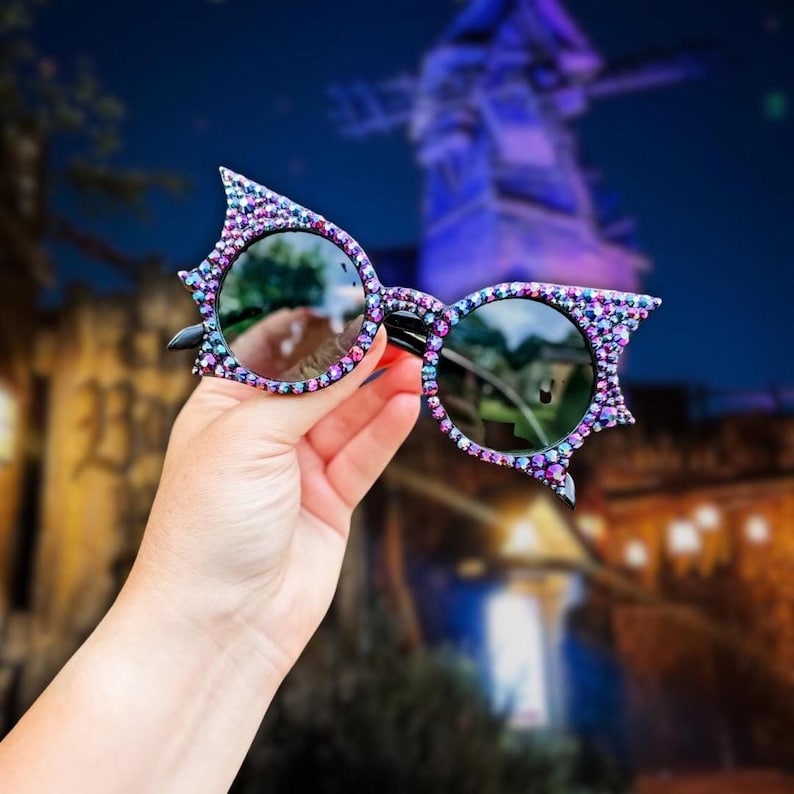 Universal Epic Universe Dark Universe
	• black iridescent rhinestone 	Bat wing glasses
	•	Haunted mansion outfit accessory
	•	Villaincore sunglasses
	•	Handmade goth accessories
	•	Festival or theme park sunglasses
	•	Horror glam fashion