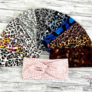 Può includere: Una collezione di fasce per capelli con vari motivi animalier, tra cui disegni leopardati e ghepardo. Le fasce sono disponibili in una varietà di colori, come rosa, blu, marrone e grigio. Le fasce sono realizzate in un materiale morbido ed elastico.
