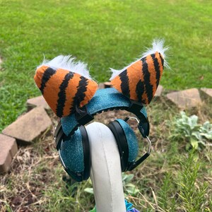 May include: Blue headphones with a sparkly finish and tiger-striped earmuffs with white fur trim.