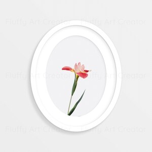 May include: A single pink and white flower with green leaves is framed in a white oval frame against a white background.