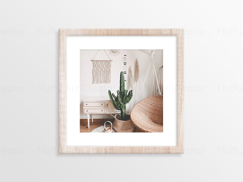 May include: A framed print featuring a bohemian-style interior. The image showcases a cactus in a woven basket, a wicker chair, a macrame wall hanging, and a white dresser. The color palette is neutral with natural wood tones and a touch of green.
