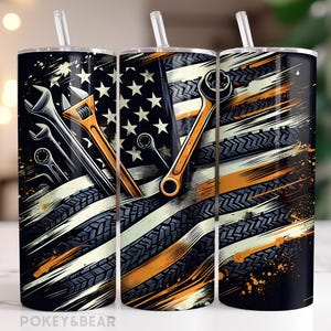 May include: Three stainless steel tumblers with a patriotic American flag design and a graphic of tools, including wrenches and screwdrivers. The tumblers are black with white stripes and orange accents.