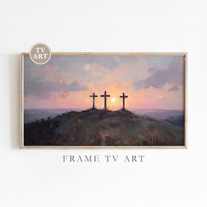 May include: Framed artwork depicting three crosses silhouetted against a sunset. The painting features a color palette of purples, oranges, and yellows, with the text "FRAME TV ART" at the bottom.