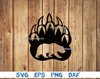 May include: Black silhouette of a bear paw print with trees inside the paw prints. The bear is walking inside the paw print. The image is on a wood background.