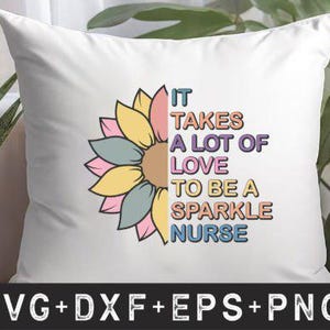 May include: White cushion featuring a colourful sunflower design and the text "IT TAKES A LOT OF LOVE TO BE A SPARKLE NURSE." The cushion is set against a backdrop of greenery and a woven basket.