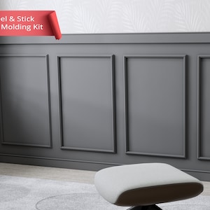 May include: Peel and Stick Wall Moulding Kit, a grey wall panel with a decorative moulding design. The moulding is made of a peel and stick material, making it easy to install.