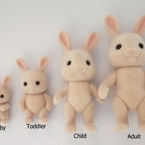 May include: Four plush white rabbit figurines of varying sizes, labeled "Baby", "Toddler", "Child", and "Adult".
