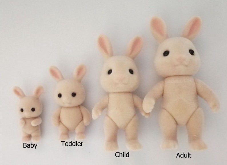 May include: Four plush white rabbit figurines of varying sizes, labeled "Baby", "Toddler", "Child", and "Adult".