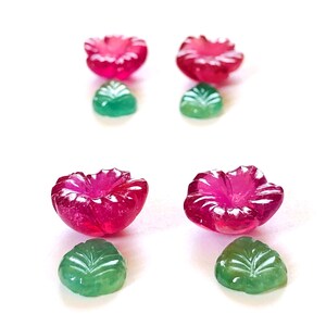 May include: Four carved gemstone flower earrings, two pink and two green. The pink flowers are larger than the green leaves.