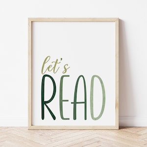 May include: A framed print with the text "let's READ" in green and gold lettering on a white background.