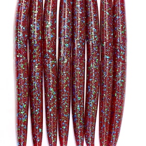 May include: Ten red, blue, and green glitter worm fishing lures.