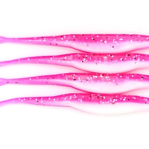 May include: Four pink and white soft plastic fishing lures with glitter accents are stacked on a white background. Each lure has a slender body and a forked tail. The lures are designed to attract fish.