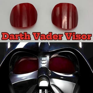 May include: Two red, curved visor lenses and a close-up of a Darth Vader helmet. The text "Darth Vader Visor" is displayed in red letters with a black outline above the helmet.