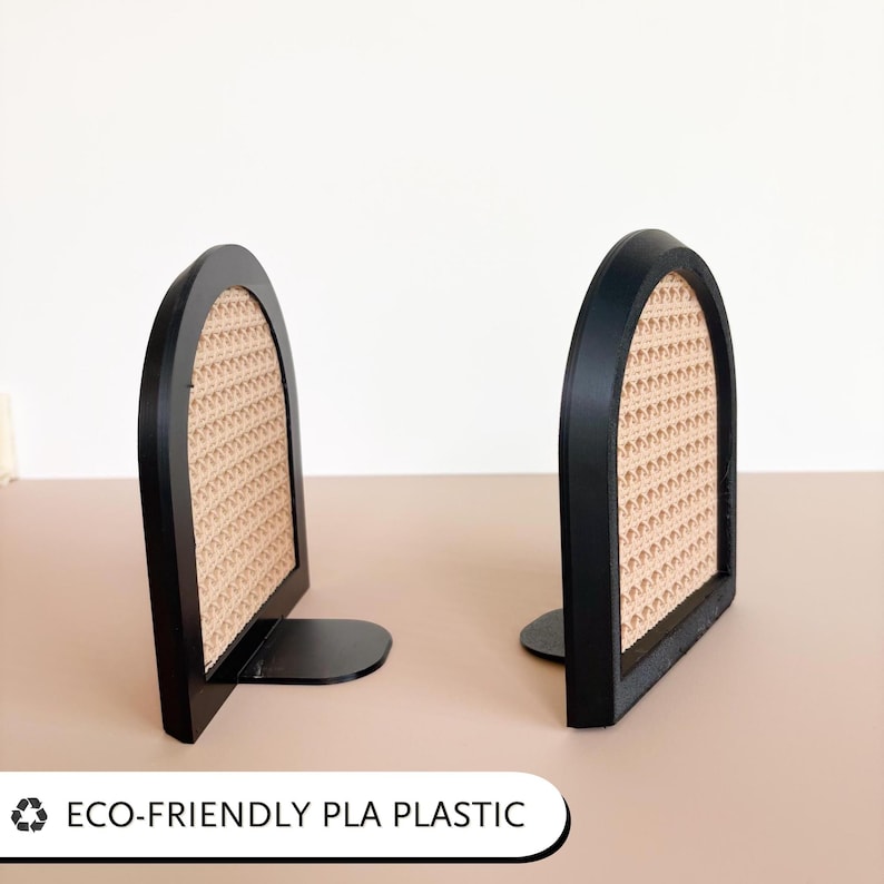 May include: Two black bookends with a woven rattan-style center. The bookends have a curved top and a flat base. The text "ECO-FRIENDLY PLA PLASTIC" is at the bottom.