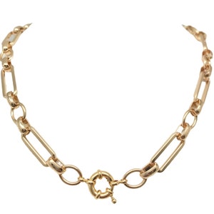 May include: A gold chain necklace with a large, chunky link design. The necklace has a lobster clasp closure.