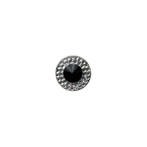 May include: A black rhinestone golf ball marker with a clear crystal border.
