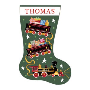 May include: A green Christmas stocking with the name "THOMAS" in red letters. The design includes illustrations of trains laden with gifts, set against a backdrop of white stars.