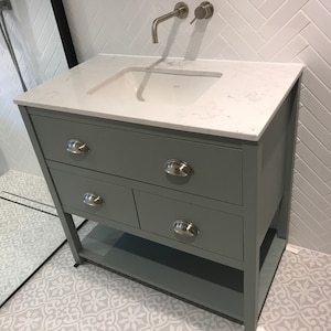 Painted vanity unit with single undermount basin.