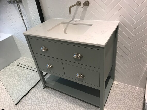 Painted vanity unit with single undermount basin.