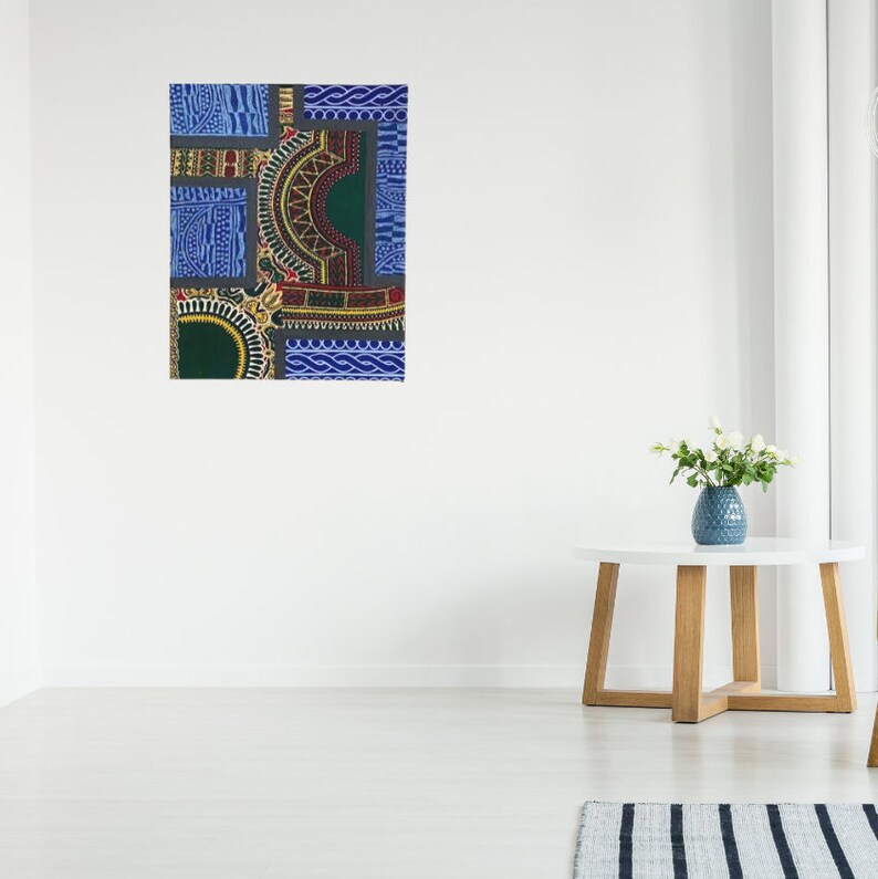 May include: A colorful abstract art print with geometric shapes and patterns in shades of blue, green, red, and gold. The print is framed and hanging on a white wall.