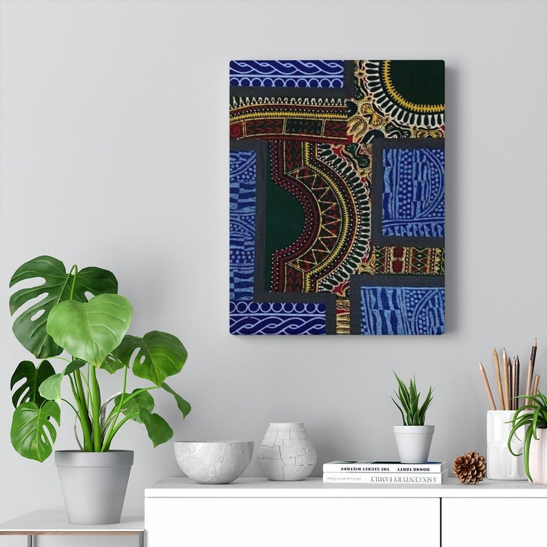 May include: A colorful abstract art print with geometric patterns in shades of blue, green, red, and yellow. The print is framed and hanging on a white wall.