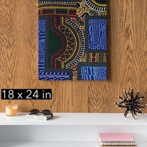May include: A colorful abstract canvas print with geometric patterns in shades of blue, green, red, and yellow. The print is 18 inches by 24 inches.