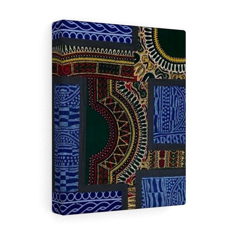 May include: A square canvas print featuring a patchwork design of colorful geometric patterns in shades of blue, green, red, yellow, and black. The patterns are arranged in a grid-like formation, creating a visually interesting and abstract design.