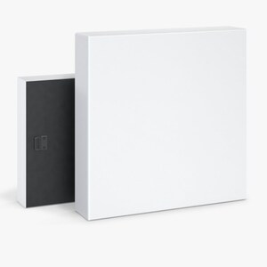 May include: A white canvas print with a black frame. The frame has a hanging mechanism on the back.