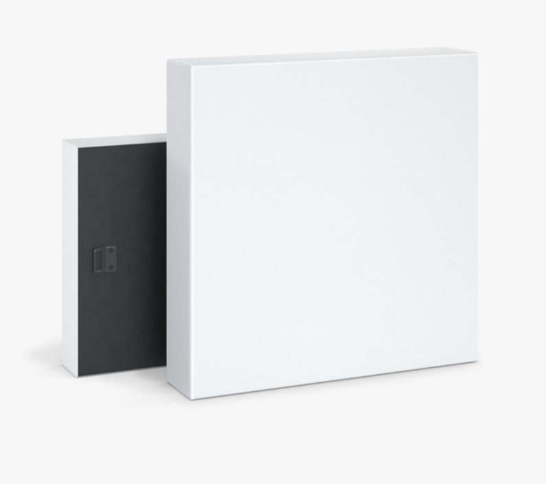 May include: A white canvas print with a black frame. The frame has a hanging mechanism on the back.