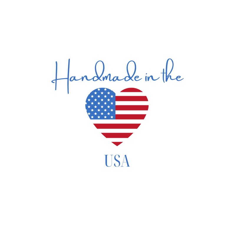May include: A white background with the words "Handmade in the" in a cursive blue font. Below is a heart-shaped American flag with the word "USA" in blue.