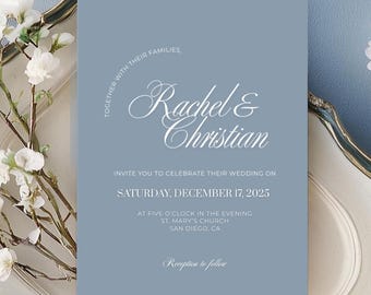 May include: A wedding invitation with a dusty blue background. The invitation features the names "Rachel & Christian" in elegant script. The text invites guests to celebrate the wedding on Saturday, December 17, 2025, at St. Mary's Church in San Diego, CA.
