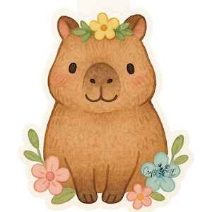 Könnte beinhalten: Aquarell-Illustration eines Capybaras mit Blumenkranz und umgeben von Blumen. Das Capybara ist braun mit rosigen Wangen und einem lächelnden Gesichtsausdruck. Die Blumen sind rosa, blau und gelb, mit grünen Blättern. Der Text "Crafts & Thi" ist sichtbar.