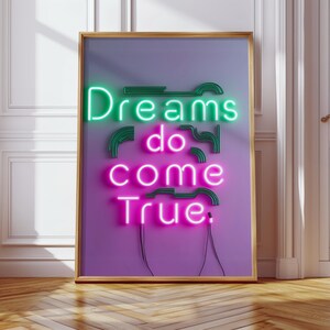 Stampa artistica da parete al neon "I sogni diventano realtà" - Poster con citazione ispiratrice vibrante, effetto luminoso rosa e verde, decorazione motivazionale per la casa