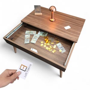 May include: A wooden coffee table with a sliding top that reveals a hidden storage compartment. Inside the compartment are stacks of US dollar bills, gold-colored bars, and jewelry. A small copper-colored lamp sits on the table surface.