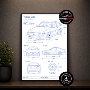 May include: Blueprint-style print of a Trueno AE86 2-door hatchback car. The print includes front, side, and rear views, along with wheel details and dimensions in millimeters. The text "TRUENO AE86" is at the top. The print is in a black frame.