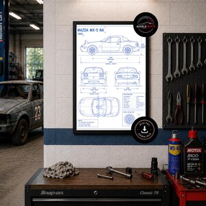 May include: A framed blueprint of a 1990 Mazda MX-5 NA car, displayed in a garage setting. The print shows multiple views of the car with dimensions. The garage includes tools, a toolbox, and a vintage car.