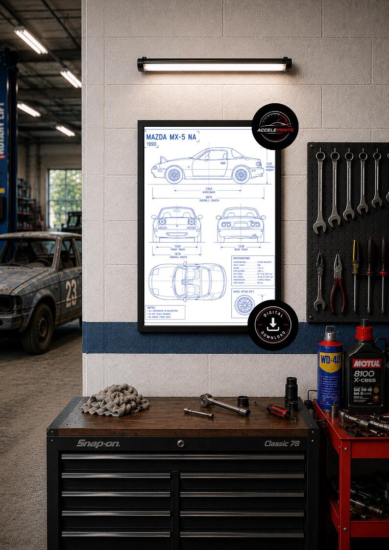 May include: A framed blueprint of a 1990 Mazda MX-5 NA car, displayed in a garage setting. The print shows multiple views of the car with dimensions. The garage includes tools, a toolbox, and a vintage car.