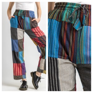 May include: Multicoloured striped trousers with a patchwork design. The trousers have a drawstring waist and are made of a soft, comfortable fabric.