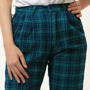 May include: Green and blue plaid pants with a button closure.