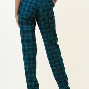 May include: Green and black plaid pants with a straight leg fit.