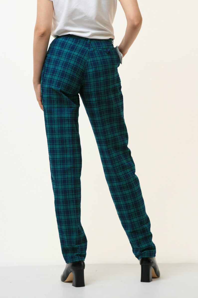 May include: Green and black plaid pants with a straight leg fit.