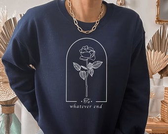 May include: Navy blue sweatshirt with a white outline of a rose in an arch with the text "...To... whatever end" underneath.