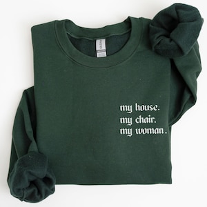 May include: Forest green sweatshirt with the text "my house. my chair. my woman." in white.